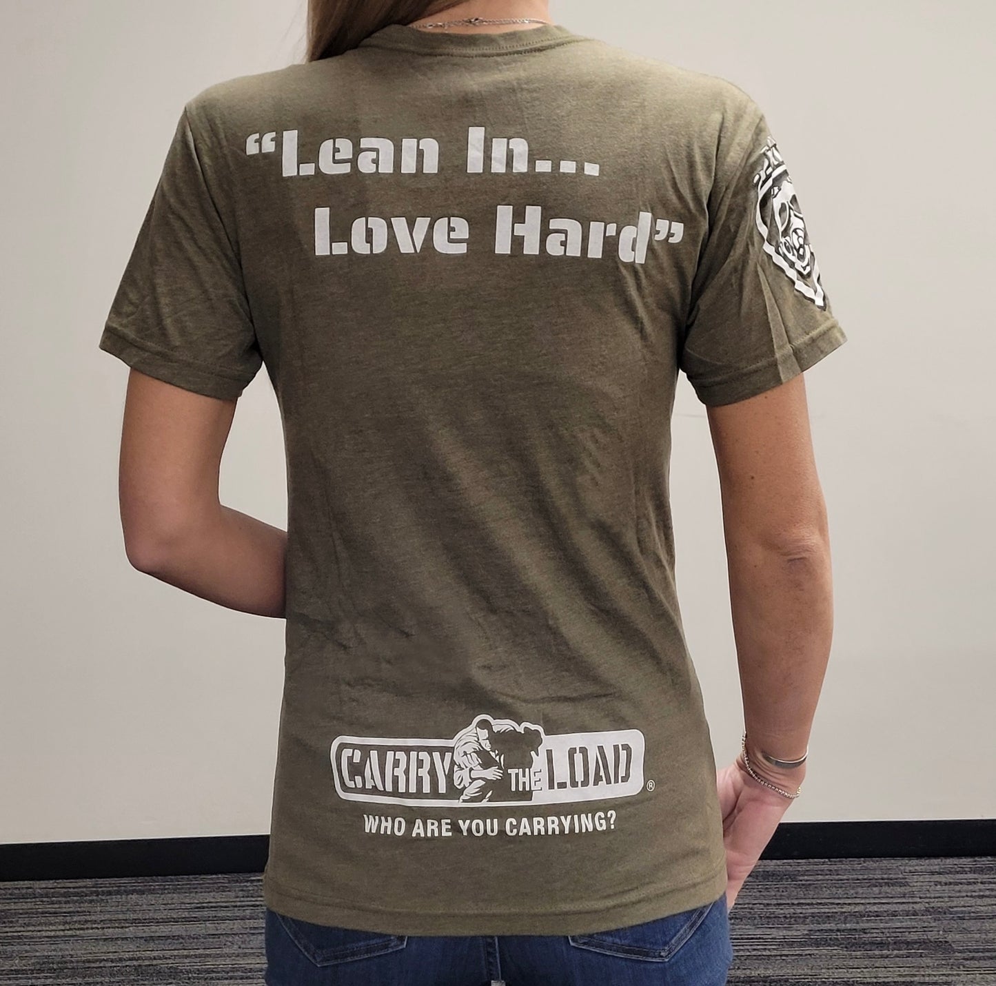 Carry The Load 2023 T-Shirt with white OTF shield on front. "Lean In, Love Hard" on back. Tri-blend material in ODG.