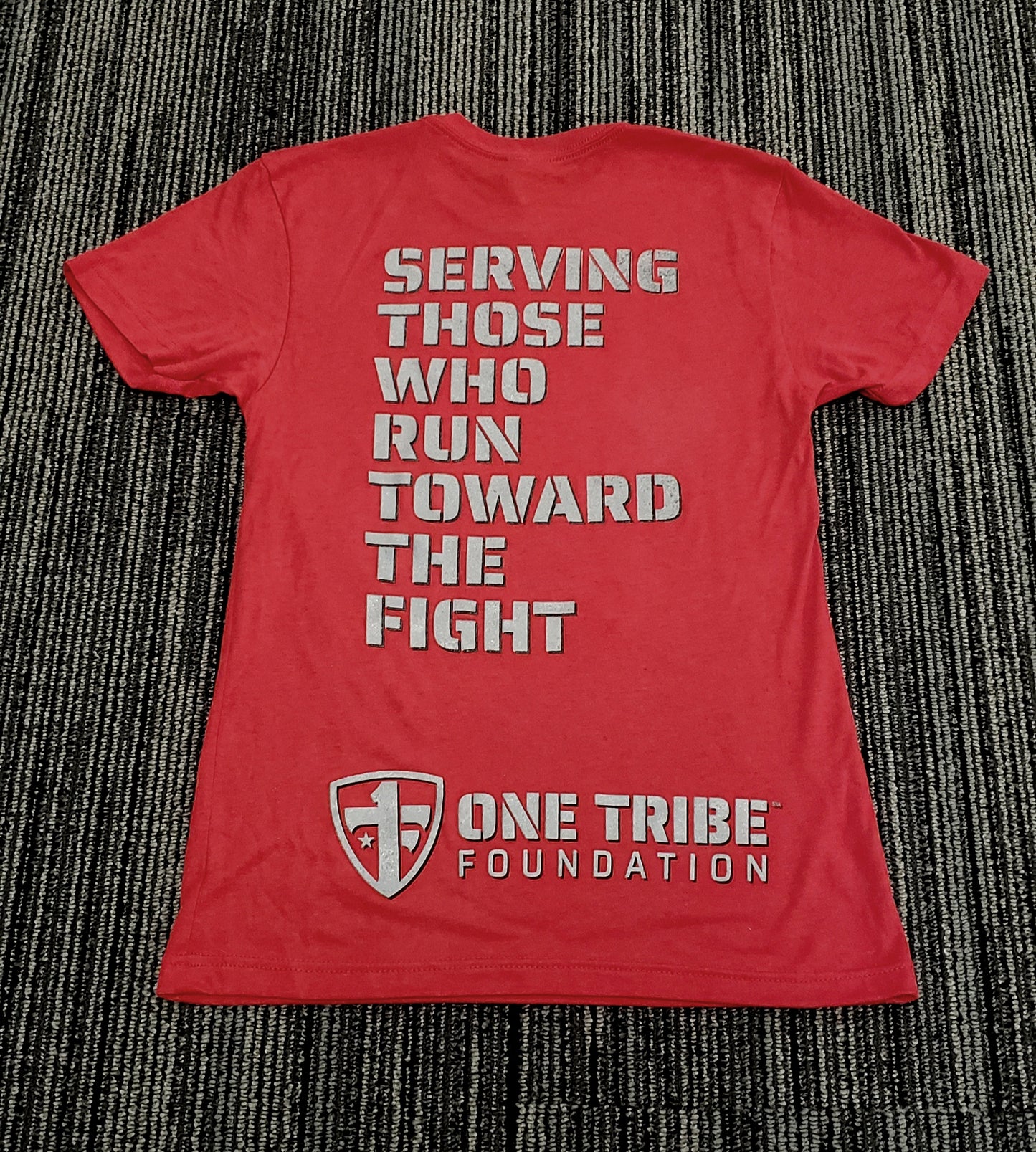 One Tribe Foundation OTF Shield in red. Serving those who run toward the fight.