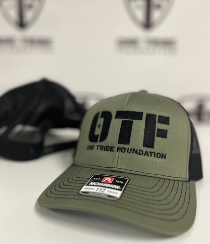 One Tribe Foundation trucker hat in loden/black. 