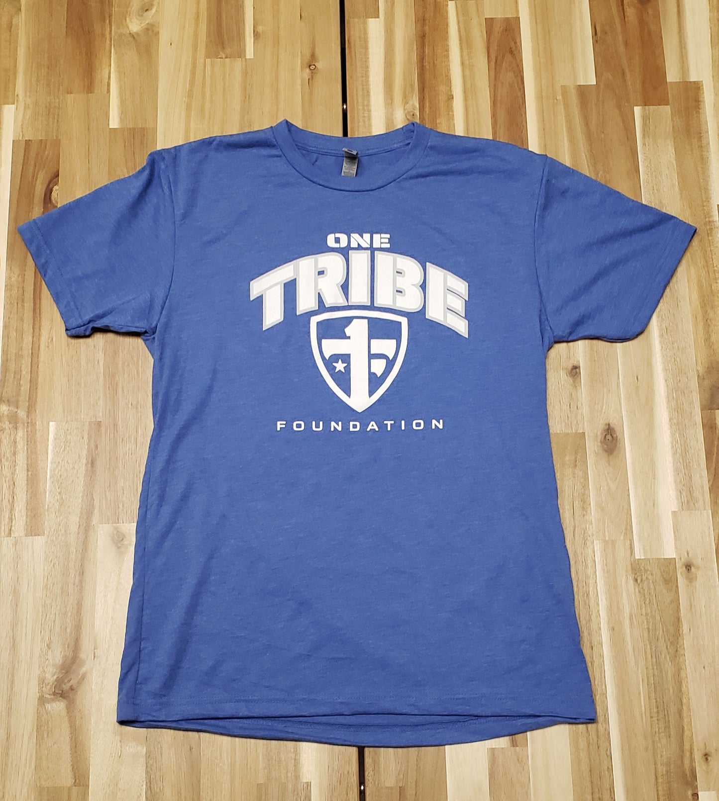 One Tribe Foundation royal blue t-shirt.